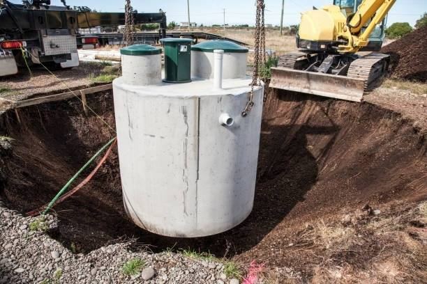 Large concrete septic tank being installed at a commercial site