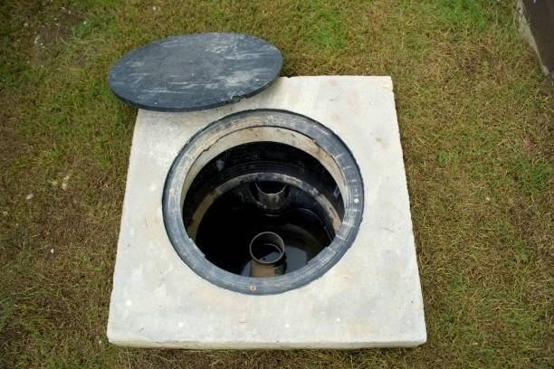 Open concrete grease trap with the lid removed