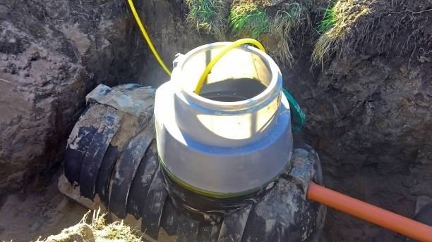 Septic riser being installed on a plastic tank for easier maintenance access